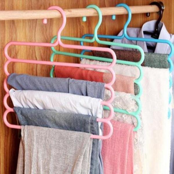 5-layer multipurpose plastic hanger in use with clothes. multipurpose plastic hanger, 5 in 1 hanger, clothes organizer, closet space saver, non-slip plastic hanger, trouser hanger, scarf belt tie organizer, wardrobe hanger set