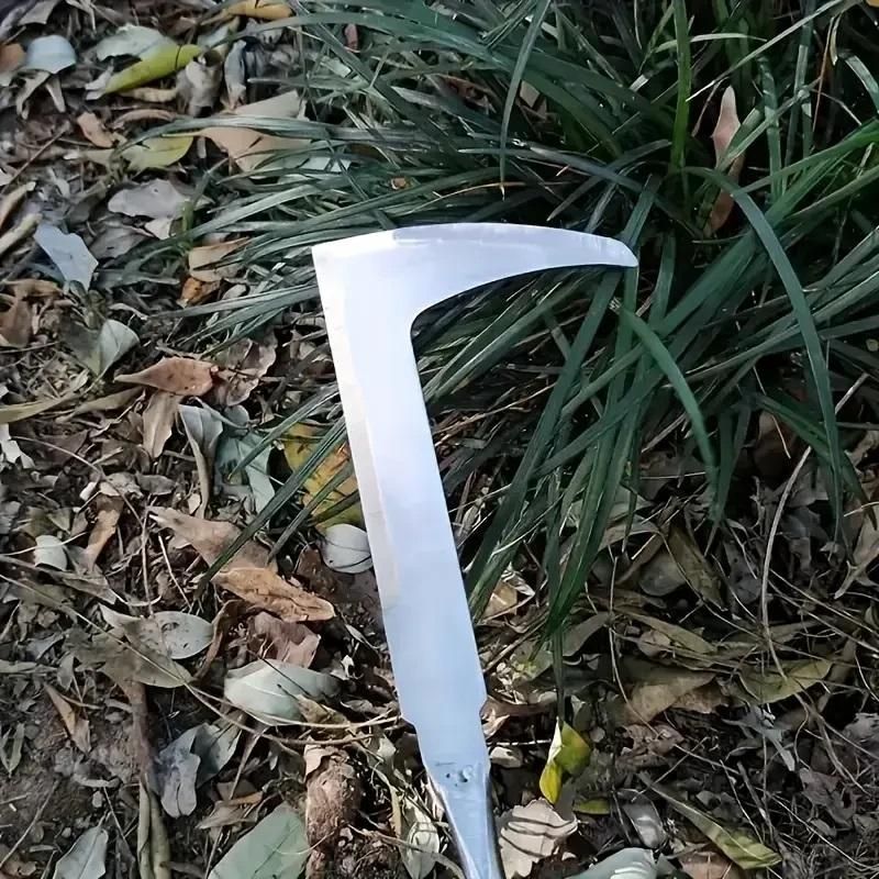 White curved blade on a ground with grass and leaves. Handheld arc weeding tool with stainless steel construction and wooden handle showing 31.8cm professional design