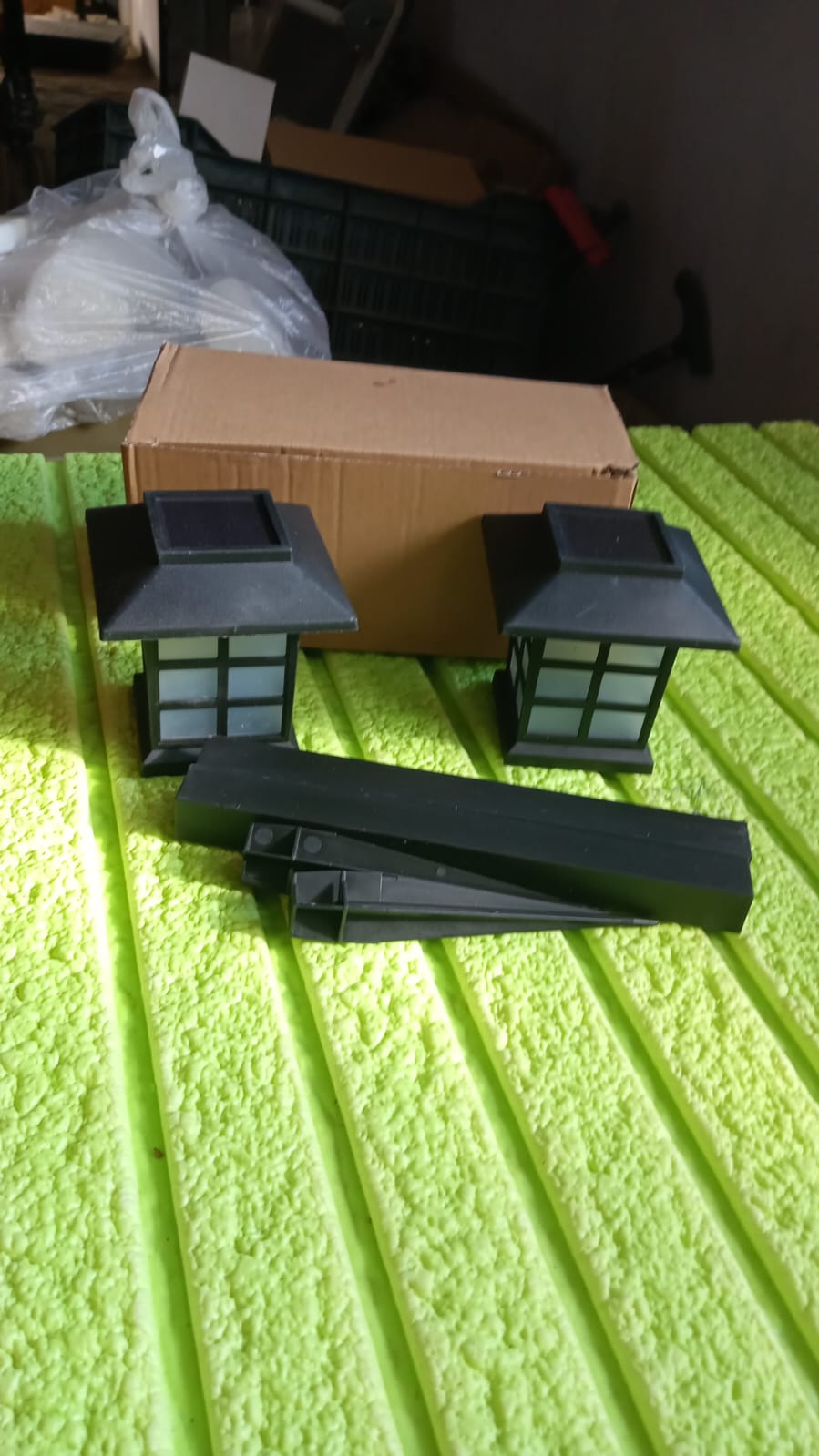 Solar powered garden lights pack placed on patio floor
