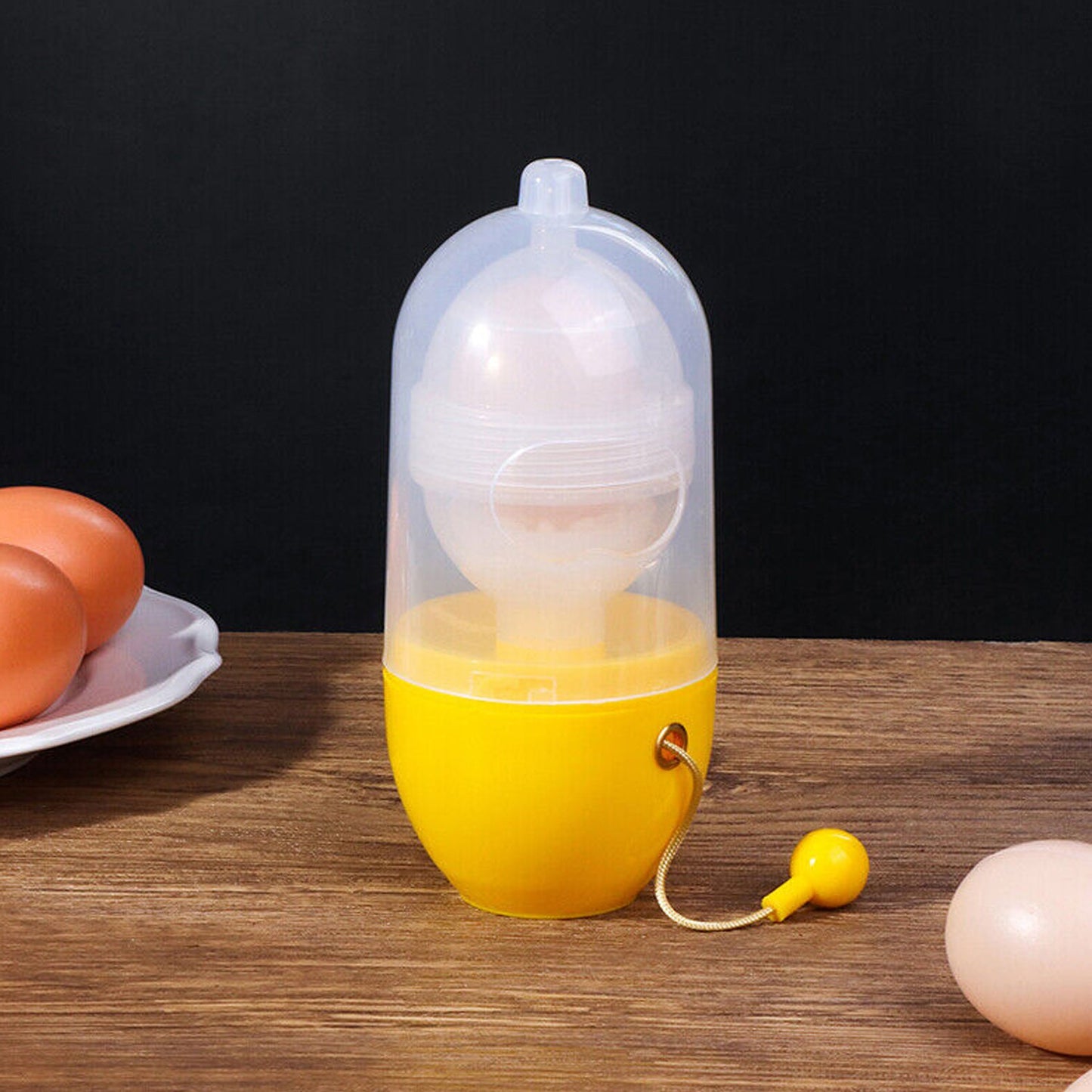 Manual egg mixer rotating tool showing mixing action