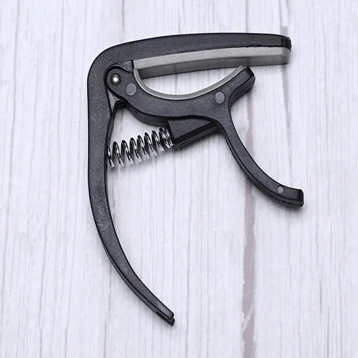 Guitar capo with pickup stand and one-hand operation pick holder, ideal for Indian music lovers