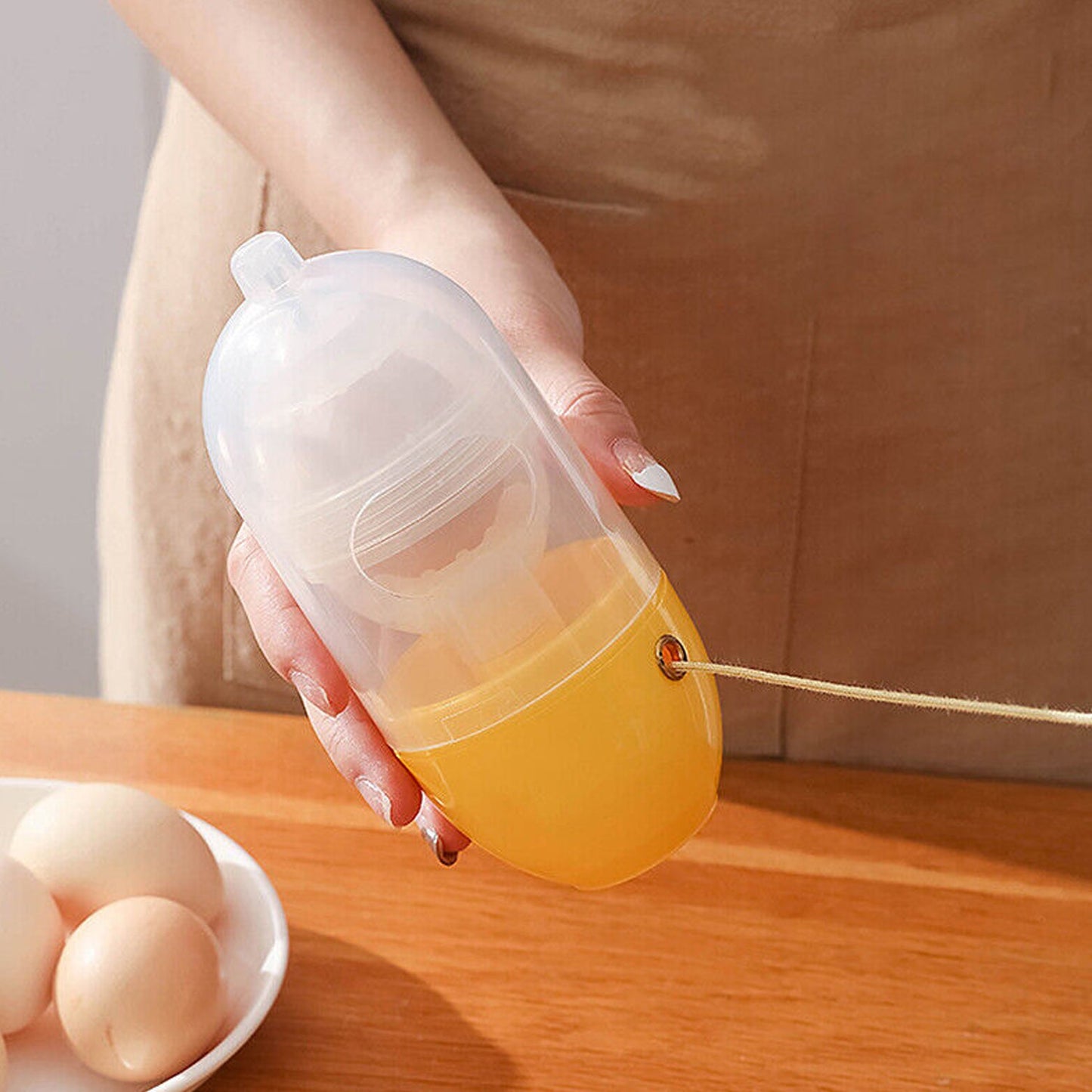 Durable transparent plastic egg mixing tool with protective pads