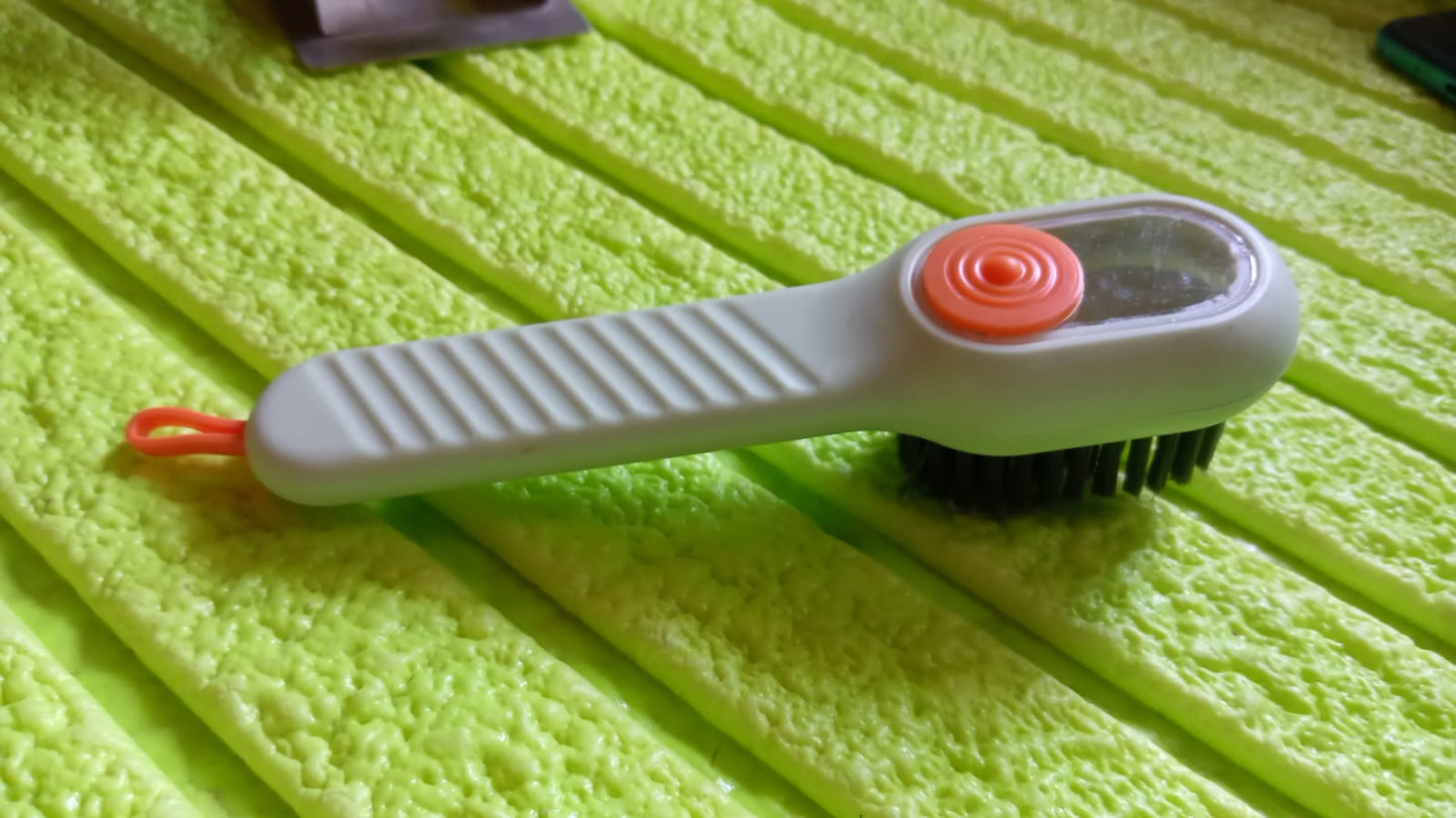 Scrubbing brush with counter-top storage cord and bristle head