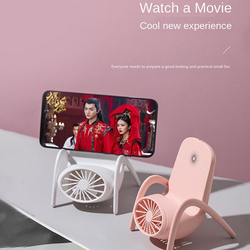Charging desk fan with integrated phone stand for travel use