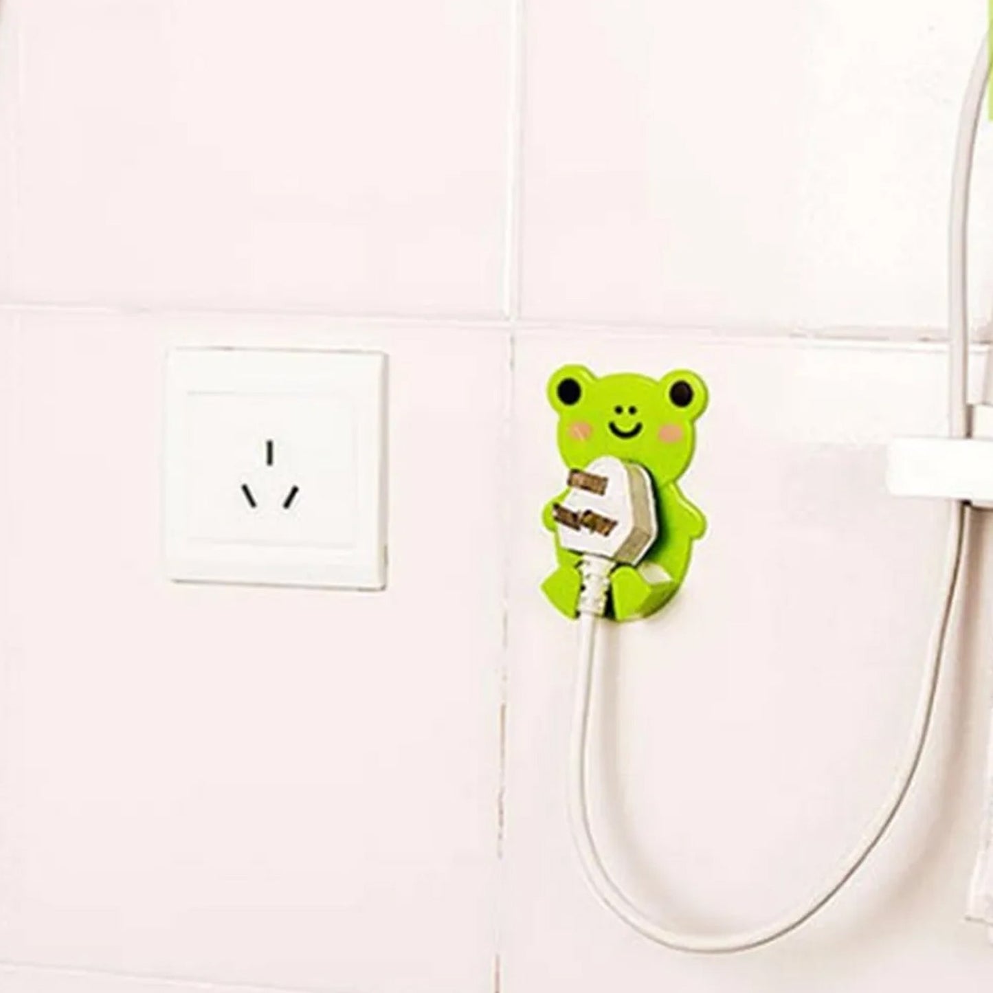 Plastic power plug hook organizing cables near electrical socket
