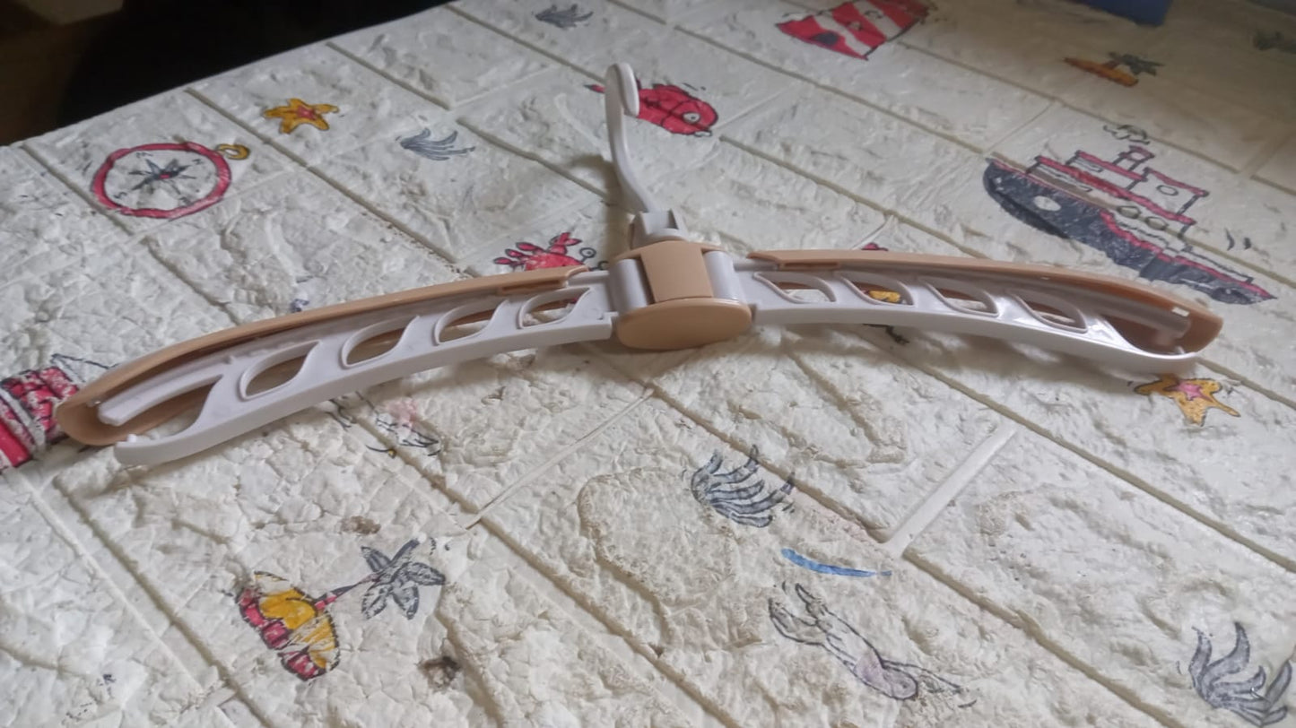 Travel-friendly clothes hanger that folds flat, space-saving for suitcases and wardrobes