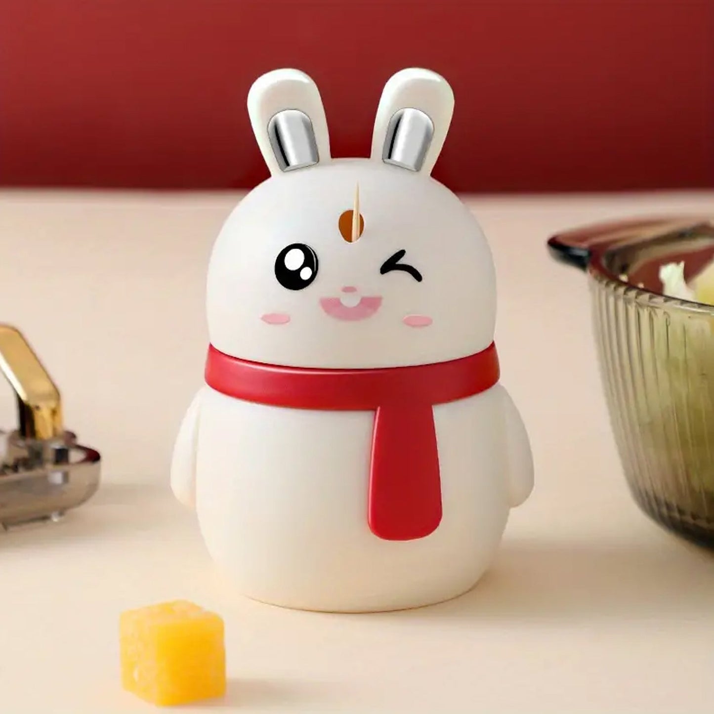 Rabbit shaped toothpick dispenser in bright red plastic on dining table