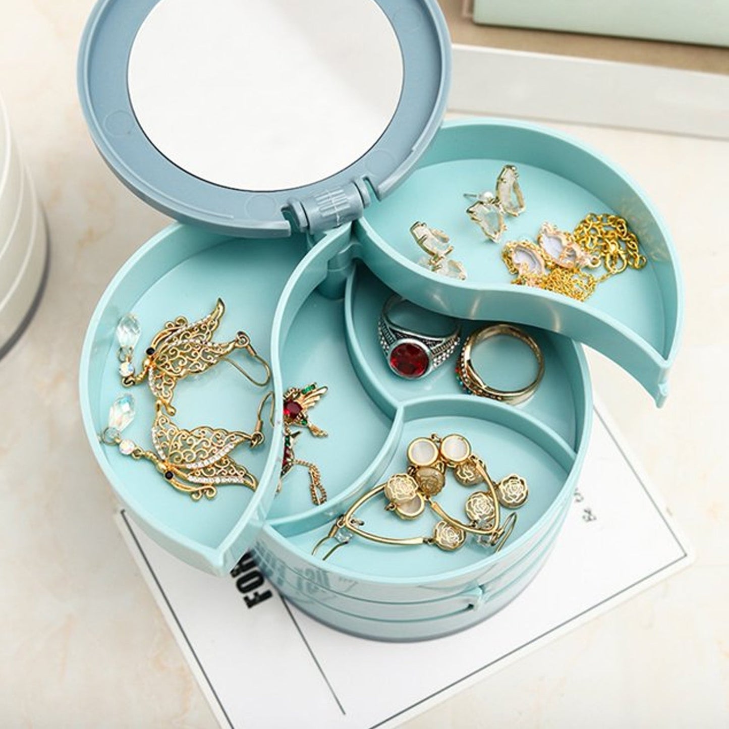 Multipurpose jewelry box with round shape and built-in mirror, perfect for home or travel use