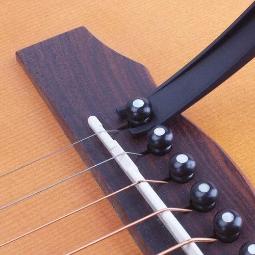 Protective guitar capo with soft plastic stand and convenient pick holder for easy access