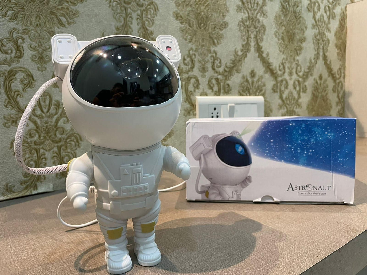 Toy astronaut figure with packaging on a patterned surface