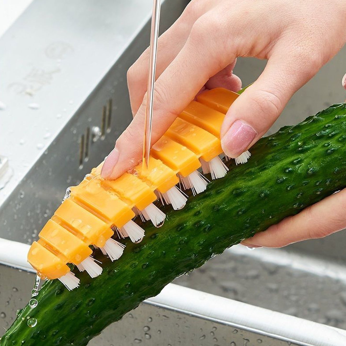 Durable vegetable cleaning brush rinsed under running water