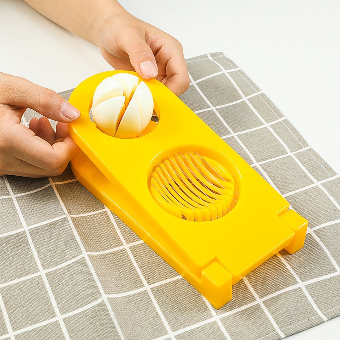 Detailed view of 2-in-1 egg cutter and slicer tool. egg slicer, stainless steel egg cutter, 2-in-1 egg slicer, kitchen egg cutter, mushroom slicer, egg cutter for salad, egg slicer for sandwich