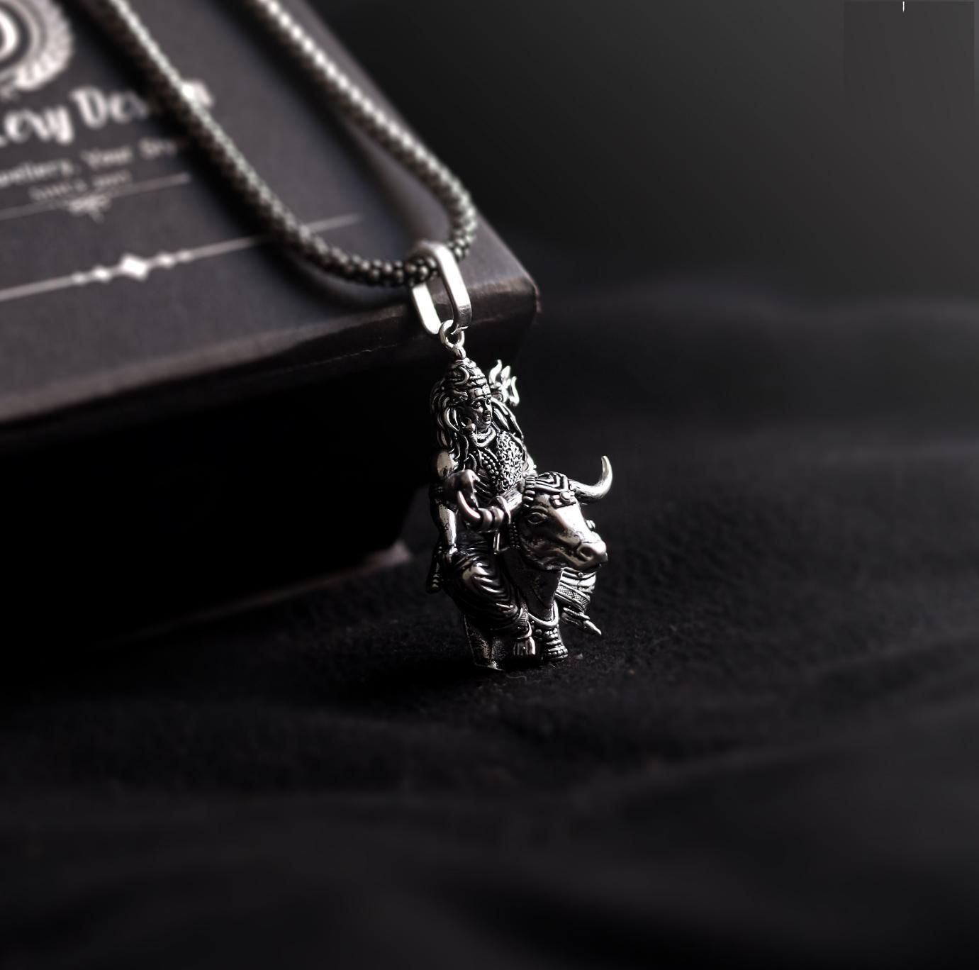 silver stainless steel shivji locket, shiva and nandi pendant necklace, lord shiva nandi pendant chain, stainless steel shivji pendant for men, silver shiva locket with nandi, spiritual shiva nandi pendant necklace, men's stainless steel lord shiva chain, shivji locket with nandi design, silver lord shiva pendant chain for men