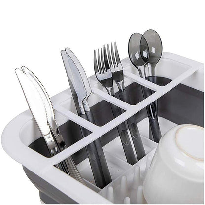Collapsible silicone rack for drying dishes and storing utensils. collapsible dish drying rack, folding kitchen drainer, silicone dish rack, drying tray with utensil holder, rustproof dish drainer, compact dish drying rack, camping dish drainer, countertop dish tray, dishwasher safe dish rack, kitchen drying stand