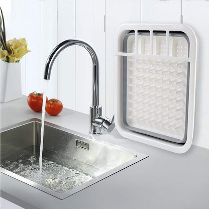 Folding silicone dish rack with storage for spoons, forks, and knives. collapsible dish drying rack, folding kitchen drainer, silicone dish rack, drying tray with utensil holder, rustproof dish drainer, compact dish drying rack, camping dish drainer, countertop dish tray, dishwasher safe dish rack, kitchen drying stand