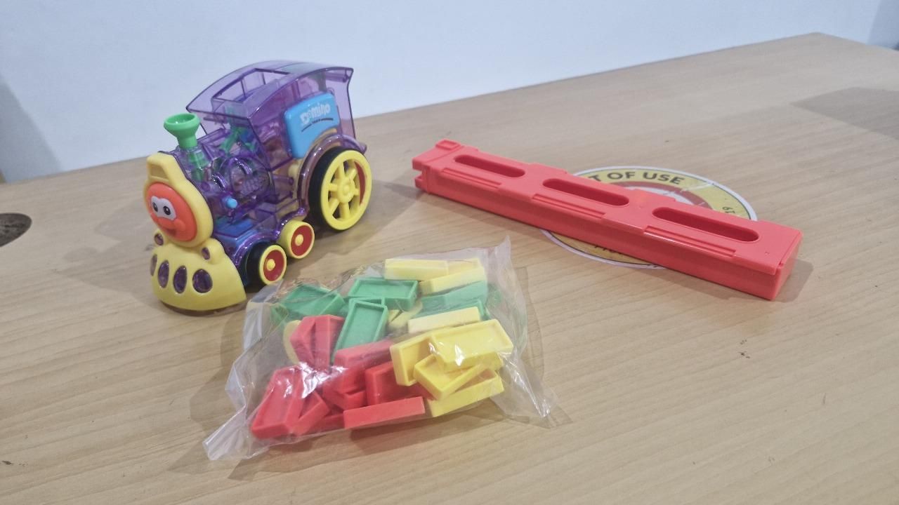 domino toy for creative play, domino building blocks train toy, safe plastic train toy for kids, battery-operated domino train toy, domino stacking toy for toddlers India, motorized domino toy train, kids toy train with blocks, domino play set with train, music-enabled domino train toy, plastic domino engine for kids, domino train toy for 3 to 6 year olds