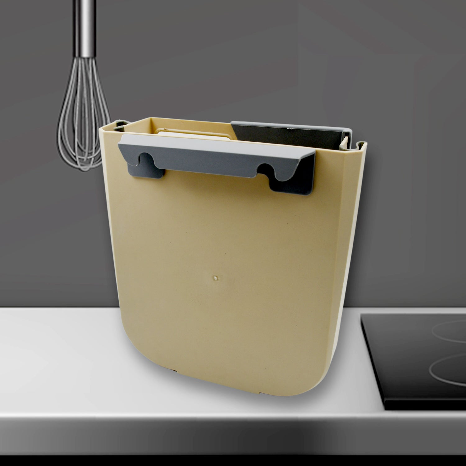 Trash bin hanging inside cabinet door for food scrap disposal while cooking