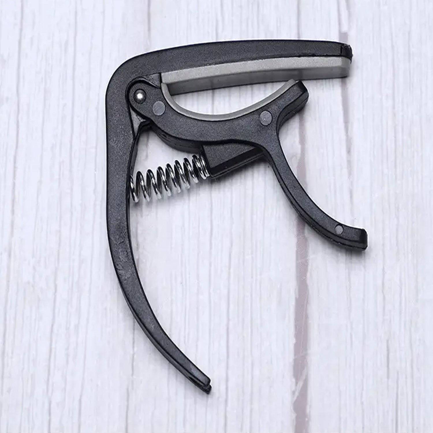 Guitar capo with pickup stand and one-hand operation pick holder, ideal for Indian music lovers