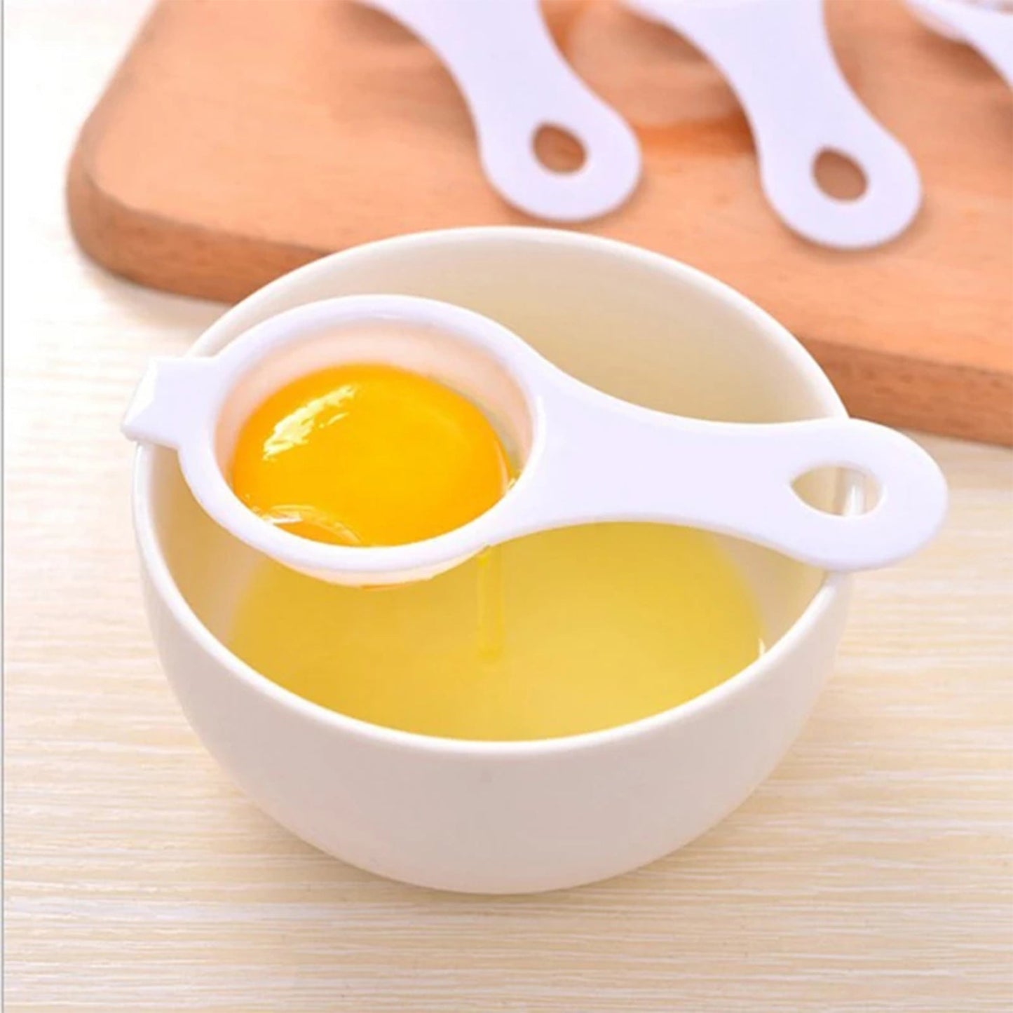 Egg separator with long handle for easy placement over bowls, making baking preparation simple
