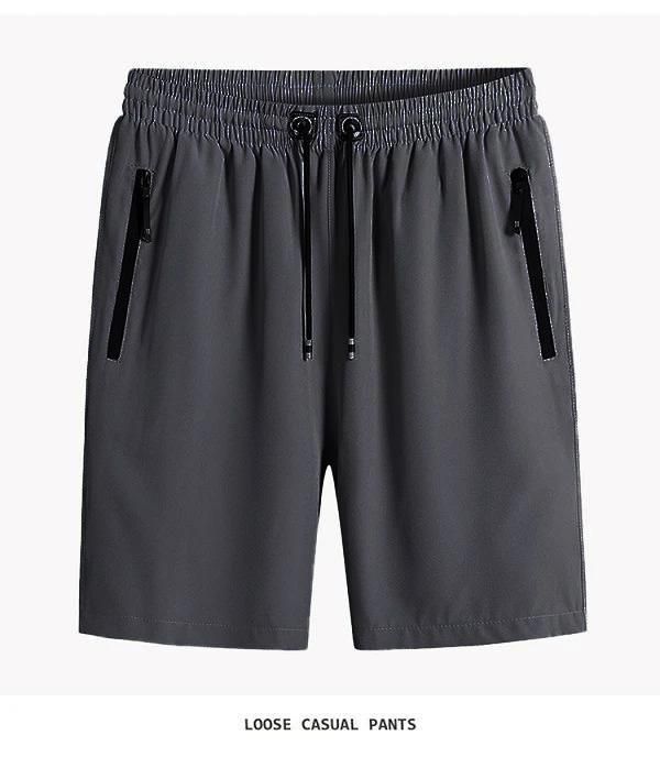 Gray loose casual pants with zippers on a white background