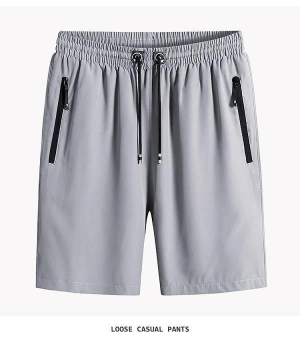 Gray loose casual pants with zippers on a white background