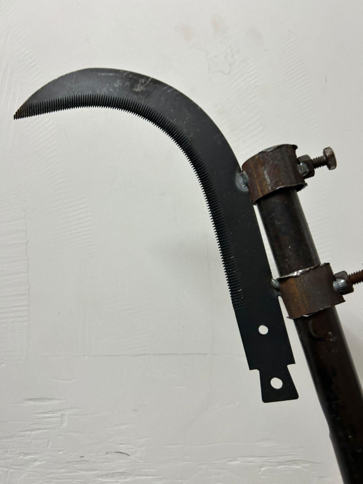 Close-up of a curved blade tool on a white background