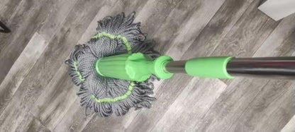 Mop with a green handle cleaning a wooden floor, Steel handle rotating mop with push-to-clean dry self twisting system for effortless floor cleaning