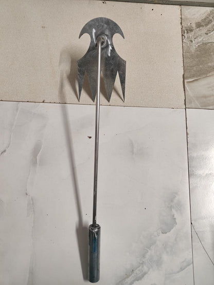 Metal tool with a curved blade and handle on a tiled floor, Weeding puller with sharp metal construction displaying compact size perfect for garden weed removal