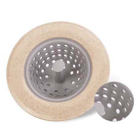 Silicone sink strainer basket with ergonomic handle on kitchen sink