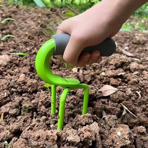 Hand using a green gardening tool in soil, Soil turning seeding gardening tool with 2.4 inch durable sharp spikes and ergonomic handle for lawn aeration