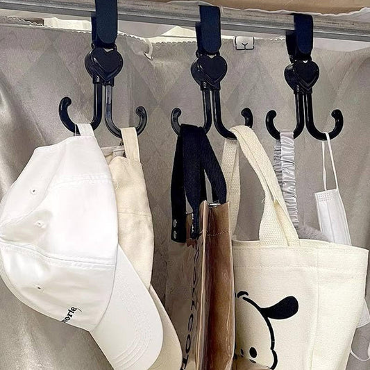 Black stroller hook attached to pushchair handle carrying shopping bag