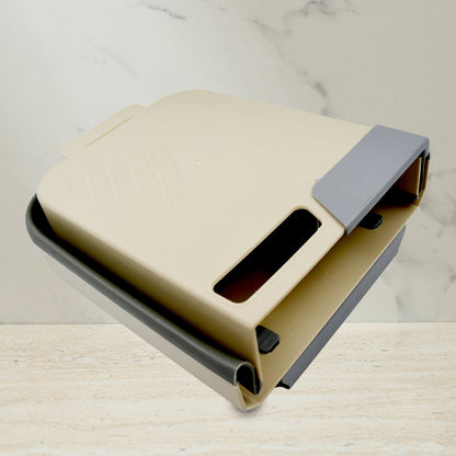 Small collapsible trash can folded flat for storage in limited spaces